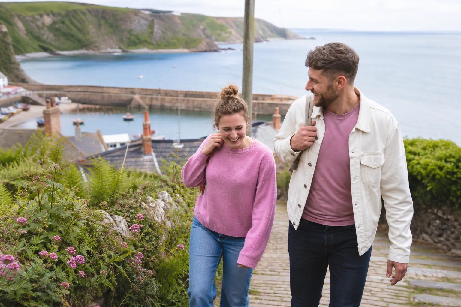 A couple walking beside the harbour in Falmouth, Cornwall