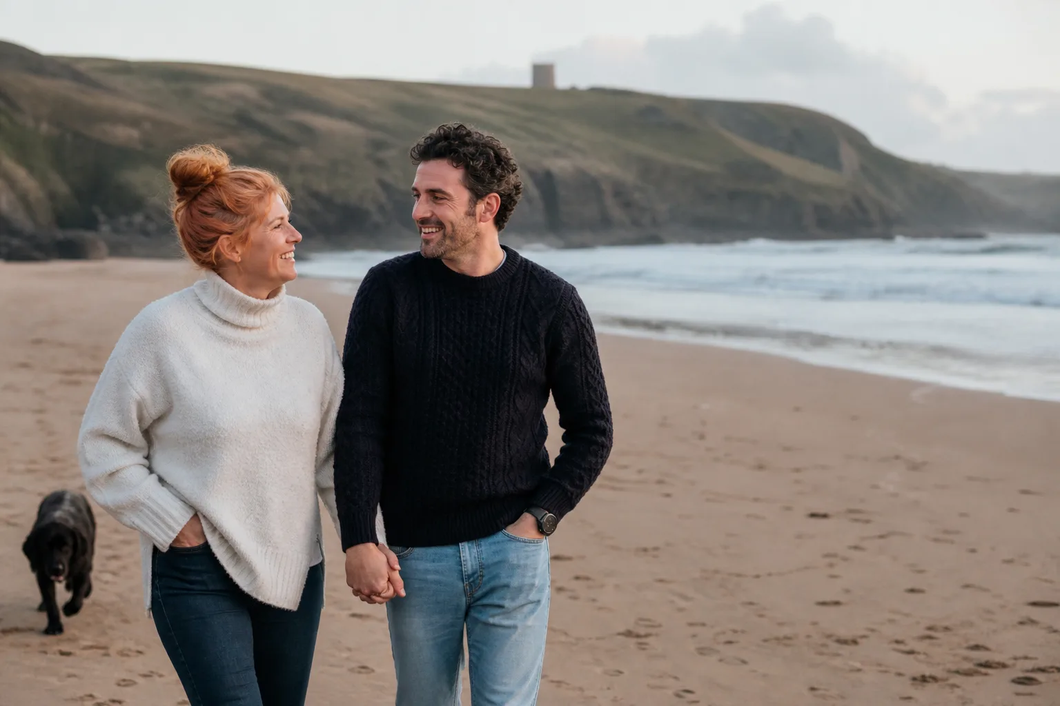 Two people walking together beside the Cornish coast
